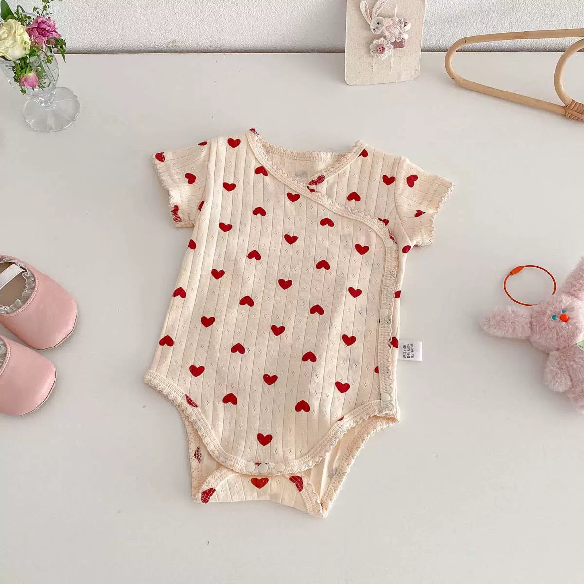 On Hand Micha Pointelle Wrap Onesie in 0-6 months