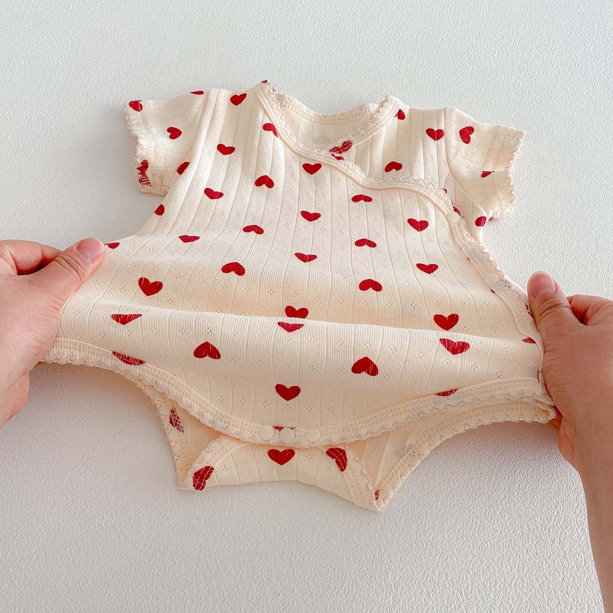 On Hand Micha Pointelle Wrap Onesie in 0-6 months